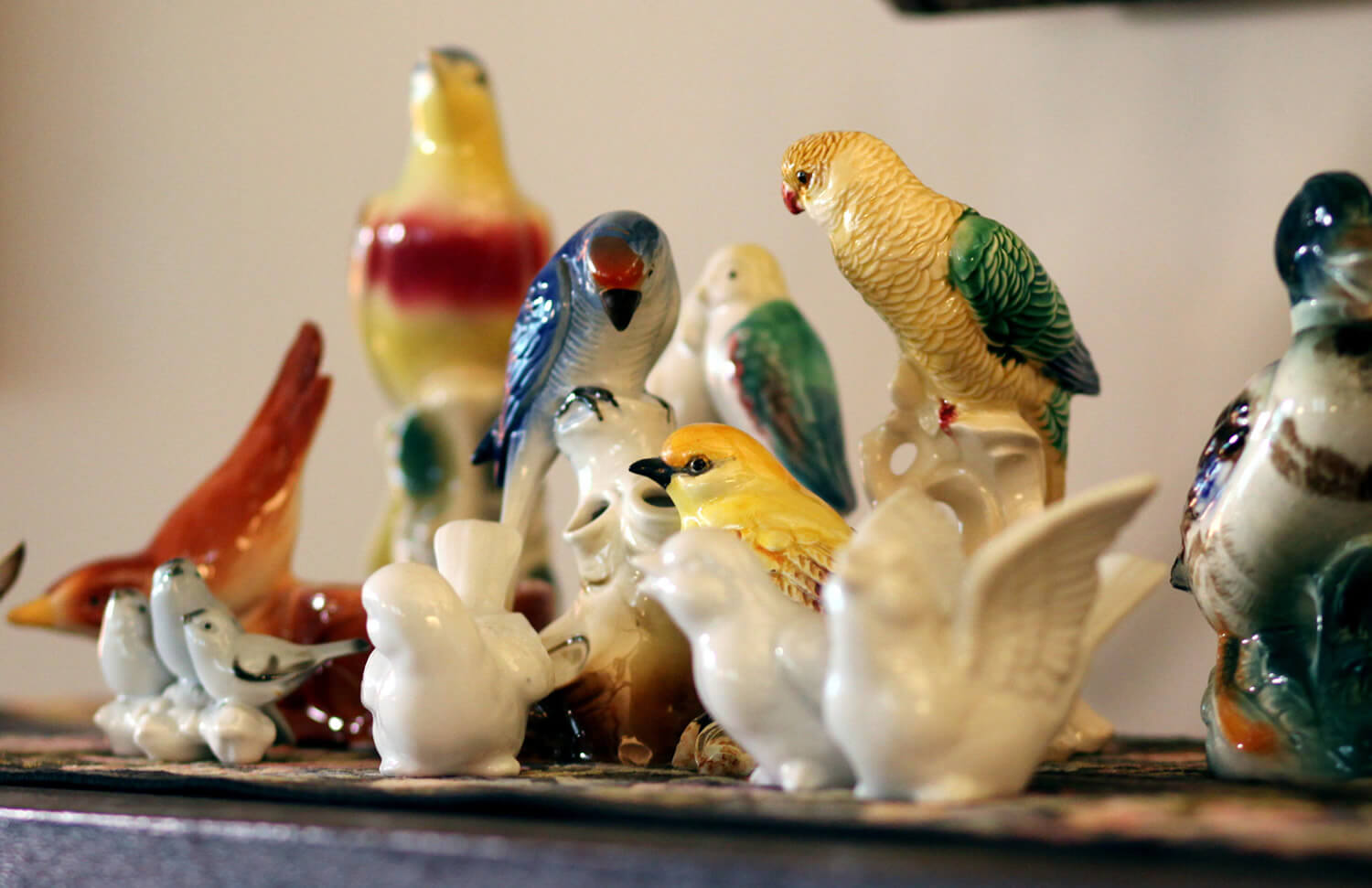 collection of ceramic birds in blue, green, red and yellow